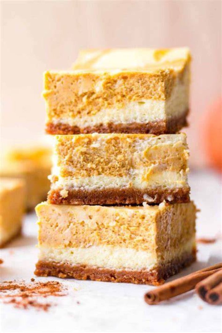 Stack of pumpkin cheesecake bars.